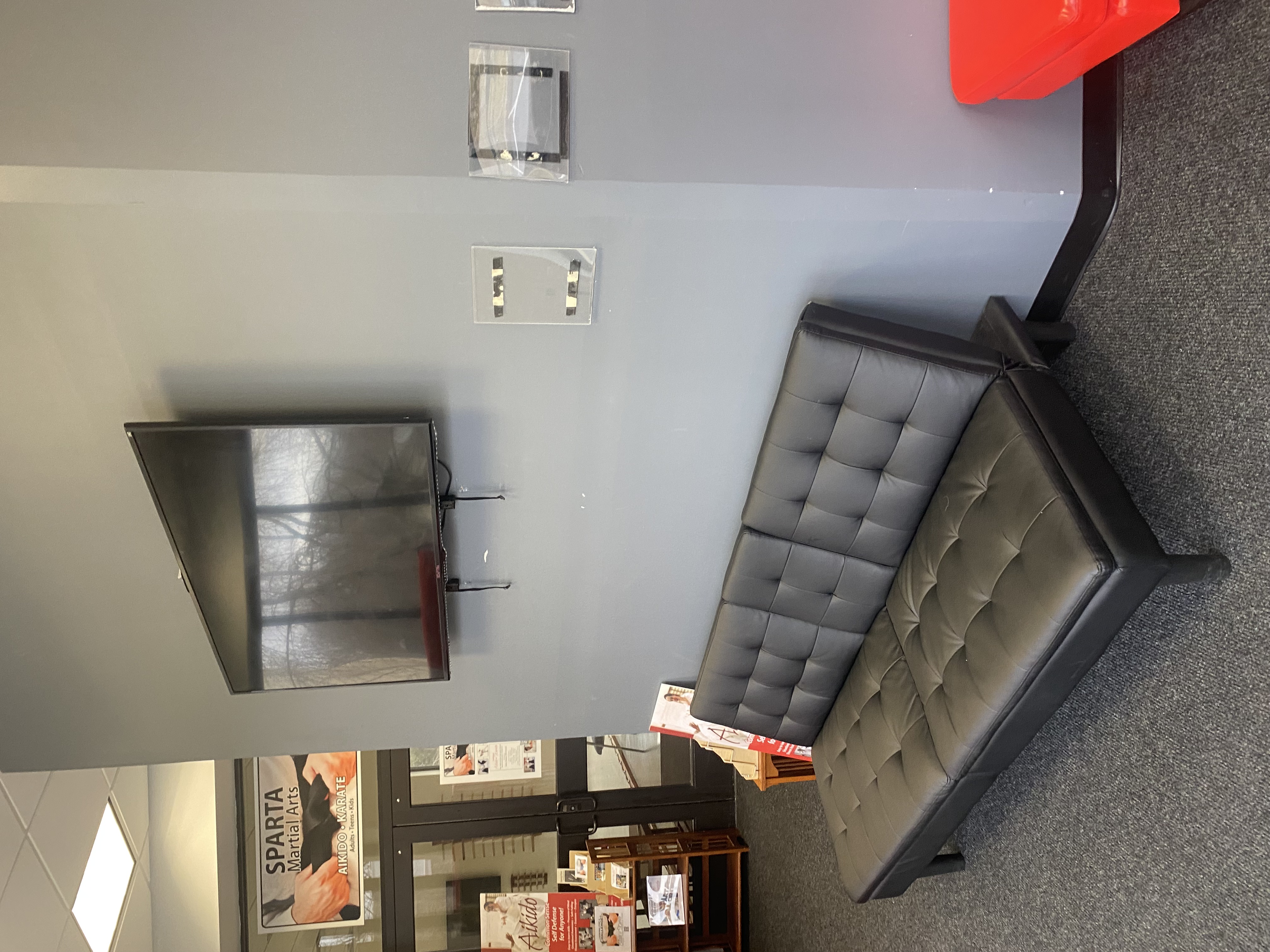 Waiting area with TV inside The House of Sports facility