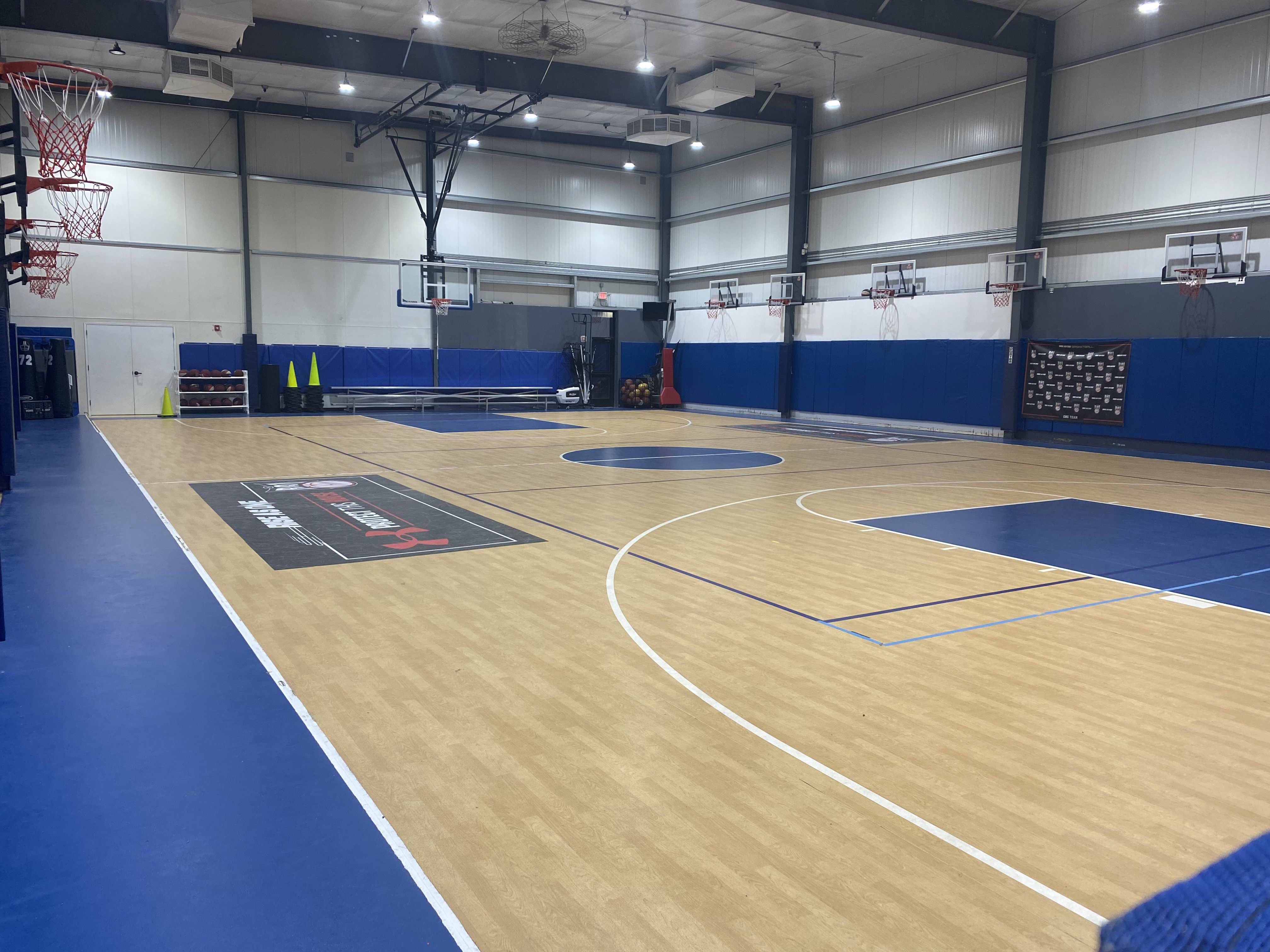 Main Arena Court at The House of Sports with professional basketball hoops and blue padding